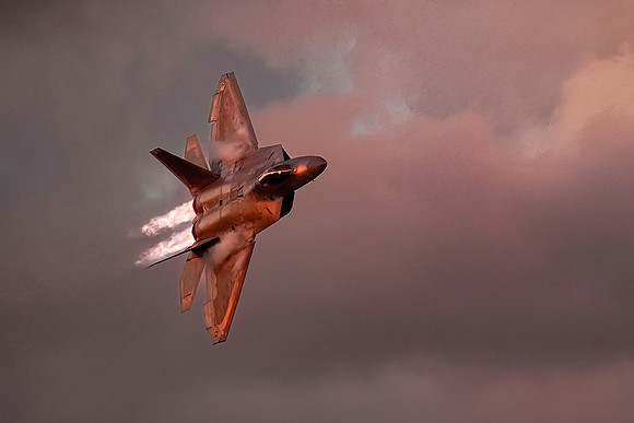 An F22 jet makes high speed passes in front of the air show crow