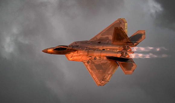 An F22 jet makes high speed passes in front of the air show crow